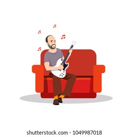 bearded man playing guitar on a couch