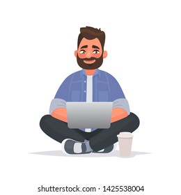 Un hombre con barba se sienta en el suelo y trabaja en un ordenador portátil. Trabajo remoto a través de Internet. Autónomo. Ilustración vectorial en estilo de caricatura