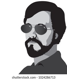 A bearded man in sunglasses is looking toward the viewer