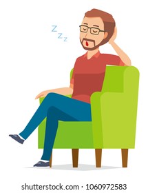 A bearded man wearing eyeglasses is sleeping on a sofa