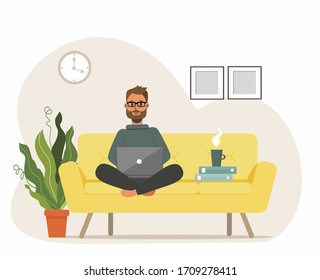 A bearded man works at a computer, laptop. Sits in lotus position on the sofa at home. Remote work from home, freelance, student. The working process. Vector illustration in cartoon style.