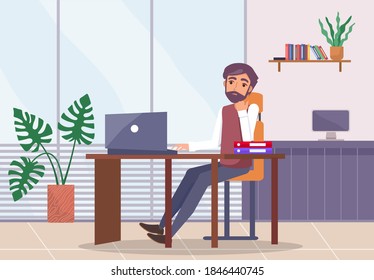 Bearded upset man sits at desk with laptop, propping face on hand, folders on table. Office space. Stress at work. Potted plant, window, monoblock. Failed business meeting. Office worker in the room