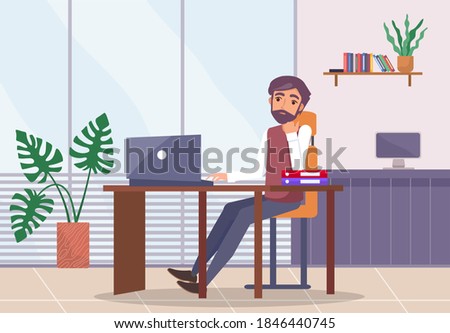 Bearded upset man sits at desk with laptop, propping face on hand, folders on table. Office space. Stress at work. Potted plant, window, monoblock. Failed business meeting. Office worker in the room