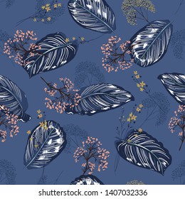 Beatiful Exotic tropical botanical  leaves and florals seamless pattern background design for fashion,web,wallpaper,fabric on dark blue background color