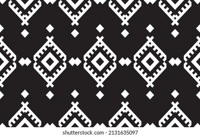 Beautiful abstract black background. Seamless pattern in tribal, folk embroidery, chevron art design. Aztec geometric art ornament print.Design for carpet, wallpaper, clothing, wrapping, fabric.