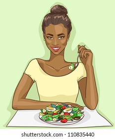 Beautiful African American smiling woman eating healthy vegetable salad