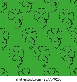 Schöner Hintergrund eines Kleeblatts mit schwarzer Markierung auf grünem Papier. Nahtlose Naturstruktur. Für Bettwäsche drucken. Das Tageskonzept von Saint Patrick. St. Patricks Hintergrund. 