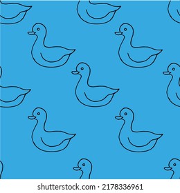 Beautiful background of toy ducks drawn with black marker on blue paper. Seamless ducks pattern. Print for bed linen.