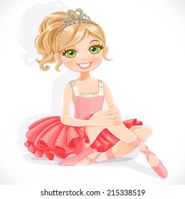 Beautiful ballerina girl in pink dress sit on floor isolated on a white background