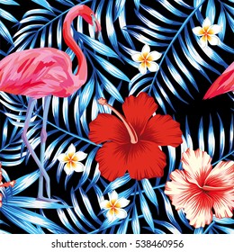 Beautiful bird pink flamingo, hibiscus and frangipani flower on a background of palm leaves in trendy blue style. Seamless vector hawaii print wallpaper pattern