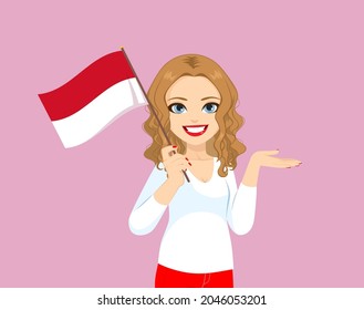 Beautiful blonde curly hair Monegasque woman holding Monaco flag making showing hand gesture 