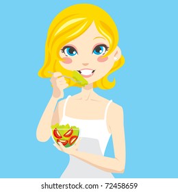 Beautiful blonde woman eating healthy vegetable salad and smiling