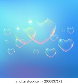 Beautiful blue background with rainbow colored heart-shaped soap bubbles. Vector illustration