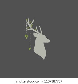 Beautiful boho card with silhouette of deer head with antlers, feathers and flowers, green leaves and wild berry sprig. Wild nature composition isolated on grey. Ethnic illustration. Spring and summer
