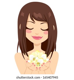 Beautiful brunette girl holding yellow spring flowers gently with her hands
