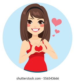 Beautiful brunette girl making heart shape with hands on Saint Valentine day