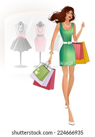 Beautiful brunette in a green dress standing near the shop. She holds a purchase. In the background a shop window.