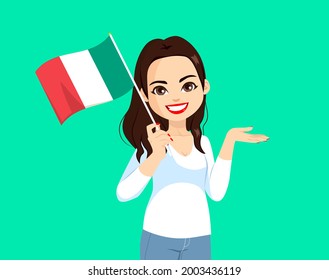 Beautiful brunette italian woman holding Italy flag on green background