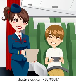 Beautiful brunette stewardess serving water to a young kid traveling and playing video games while on board