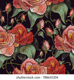 Beautiful buds of red roses classical embroidery on black background. Embroidery red roses vector seamless pattern. Template for clothes, textiles, t-shirt design