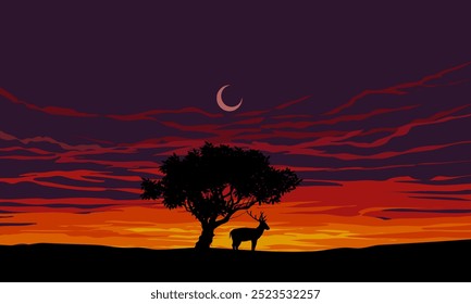 Beautiful calm sunset with silhouette of a deer standing at a tree and colorful dusk