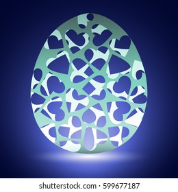 beautiful carved eggshell on blue background and with white glow