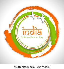 Beautiful circle in Indian National Flag colors with flying pigeons and stylish text India on grey background for 15th of August, Indian Independence Day celebrations. 