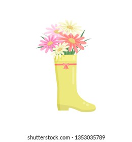 Beautiful colorful flowers composition bouquet in yellow rainboot over white
