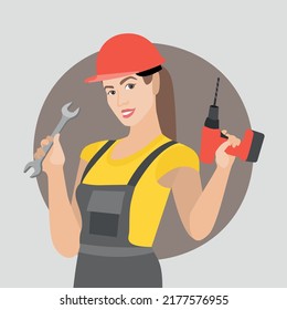  Beautiful cute smiling worker girl engineer in work uniform doing repair work with a drill screwdriver and a wrench