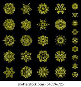Beautiful decoration 29 isolated vector snowflakes in yellow colors. Isolated watercolor snowflakes set on a black background. Symbol of winter.