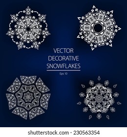 Beautiful decorative vector white winter snowflakes on a dark blue background