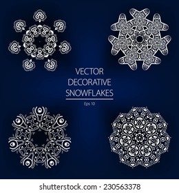 Beautiful decorative vector white winter snowflakes on a dark blue background