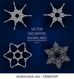 Beautiful decorative vector white winter snowflakes on a dark blue background. Calligraphic decorative elements.