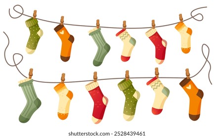 Beautiful different socks hang on a rope, secured with a clothespin. Washing, washed socks dry on a rope. Autumn and winter warm, woolen, knitted socks on a white background. An item of clothing.