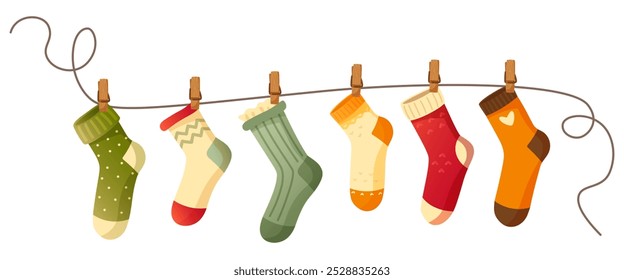 Beautiful different socks hang on a rope, secured with a clothespin. Washing, washed socks dry on a rope. Autumn and winter warm, woolen, knitted socks on a white background. An item of clothing.
