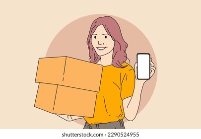 beautiful and excited young girl holding a handphone with a cardboard parcel standing over an isolated white background.