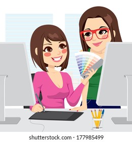 Beautiful female graphic designer picking colors from pantone palette with her assistant