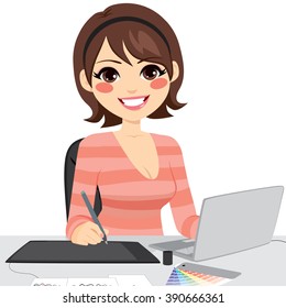 Beautiful female graphic designer working on laptop with graphic tabled and color chart