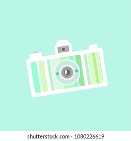 Beautiful flat creative camera of green and yellow colors. Isolated on turquoise background. Retro vector illustration. Summer adventures card. Vacation symbol