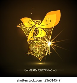 Beautiful floral design decorated golden gift box tied with ribbon on shiny brown background for Merry Christmas celebrations.