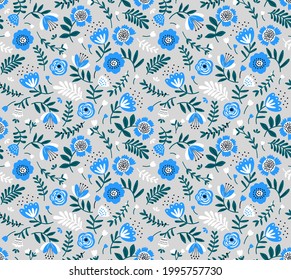 Beautiful floral pattern in folk abstract flowers. Small light blue flowers. Blue background. Ditsy print. Floral seamless background. The elegant the template for fashion prints. Stock pattern.