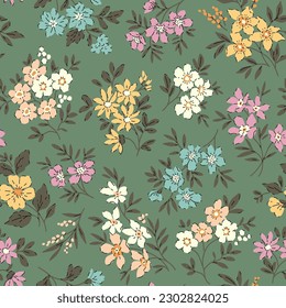 Beautiful floral pattern in retro flowers. Small colorful flowers. Green gray background. Ditsy print. Floral seamless background. Trendy template for fashion prints. Stock pattern.