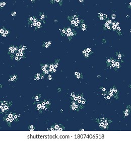 Beautiful floral pattern in small abstract flowers. Small white flowers. Dark blue background. Ditsy print. Floral seamless background. The elegant the template for fashion prints.