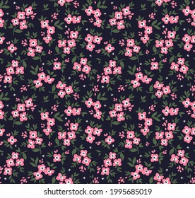 Beautiful floral pattern in small abstract flowers. Small light pink flowers. Dark Blue background. Ditsy print. Floral seamless background. The elegant the template for fashion prints. Stock pattern.