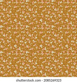 Beautiful floral pattern in small abstract flowers. Small pink and white flowers. Mustard background. Ditsy print. Floral seamless background. The elegant the template for fashion prints. Stock.