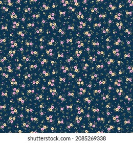 Beautiful floral pattern in small abstract flowers. Small pink and yellow flowers. Dark Blue background. Ditsy print. Floral seamless background. The elegant the template for fashion prints. Stock.