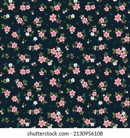 Beautiful floral pattern in small abstract flowers. Small pink flowers. Dark Blue background. Ditsy print. Floral seamless background. The elegant the template for fashion prints. Stock pattern.