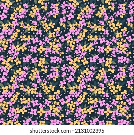 Beautiful floral pattern in small abstract flowers. Small purple and yellow flowers. Dark Blue background. Ditsy print. Floral seamless background. The elegant the template for fashion prints.