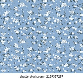 Hermoso patrón floral en pequeñas flores abstractas. Pequeñas flores blancas. Fondo azul claro. Impresión Ditsy. Fondo floral sin fisuras. La elegante plantilla para las impresiones de moda. Patrón de valores.