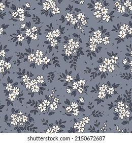 Beautiful floral pattern in small abstract flowers. Small white flowers. Gray blue background. Ditsy print. Floral seamless background. Vintage template for fashion prints. Stock pattern.
